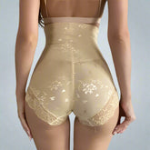 Beige shapewear with floral lace details worn by a person indoors.